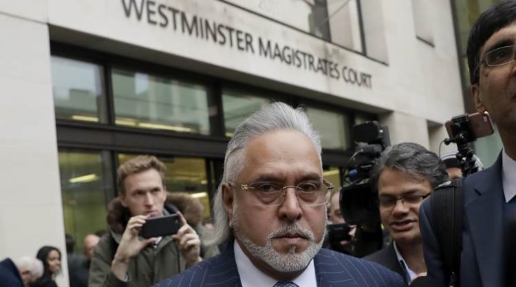 F1 Force India team boss Vijay Mallya has to leave the building after an alarm inside went off, before the start of his case on the the first day of his extradition case at Westminster Magistrates Court in London, Monday, Dec. 4, 2017. Mallya, the United Breweries Group chairman and co-owner of the Force India F1 team is wanted in India to face fraud allegations.  (AP Photo/Matt Dunham)